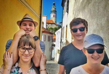 Tourists in front of Český Krumlov castle tower in Masna street
